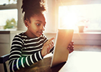 Young girl using an iPad at home
