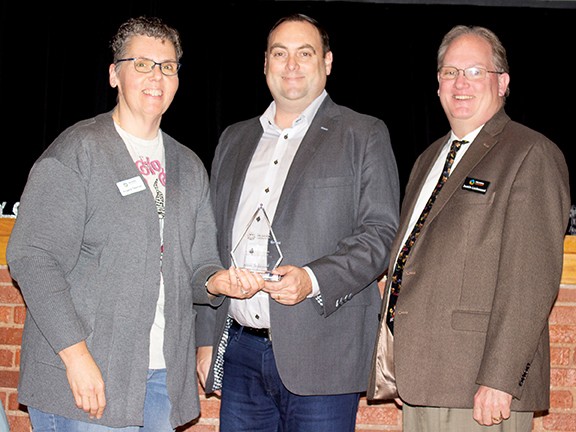 Angela Teeman, left, STEM program specialist, received the Above and Beyond Award. With her is State Board of Career and Technology Education board member Edward Hilliary Jr., center, and Oklahoma CareerTech Deputy State Director Justin Lockwood.