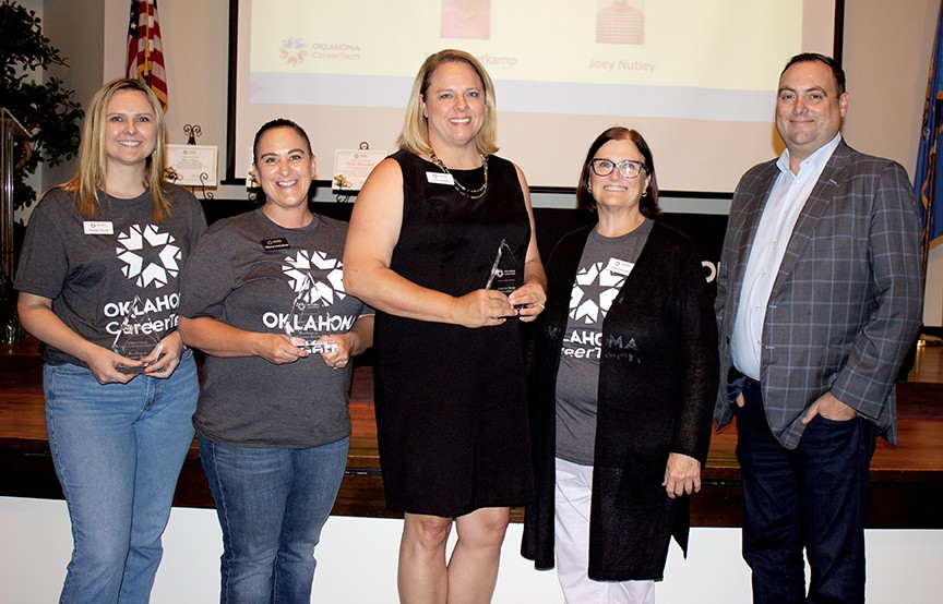Receiving Excellence in Customer Service awards were, from left, Jordan Duck, Tiffany McCollum and Cara Pattison. With them are Interim State Director Lee Denney, second from right, and Edward Hilliary, State Board of Career and Technology Education member, right.