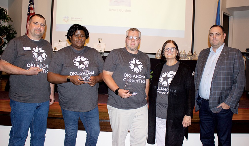 Receiving Above and Beyond awards were, from left, Steve Robison, Renae Burke and James Gordon. Not pictured is Blane Singletary. With them are Interim State Director Lee Denney, second from right, and Edward Hilliary, State Board of Career and Technology Education member, right.