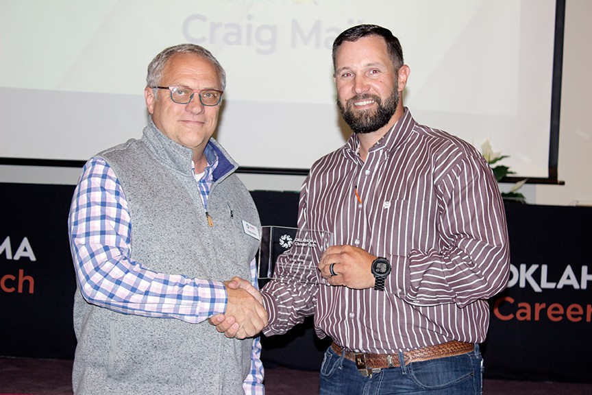 Craig Maile, left, received the Above and Beyond Award. With him is State Director Brent Haken.