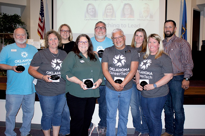 The Teaching to Lead Instructional Coaching Team received the Team Award. Pictured are, from left, Brian Campbell, Karen Talbott, Cara Pattison, Nancy Rodriguez (accepting for the late Tessa Lazor), Mitchell Thomas, Stephen Aragon, Renee Reed and Virginia Oden. With them is State Director Brent Haken, right.
