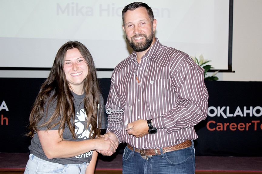 Mike Hickman, left, received the Excellence in Customer Service Award. With her is State Director Brent Haken.