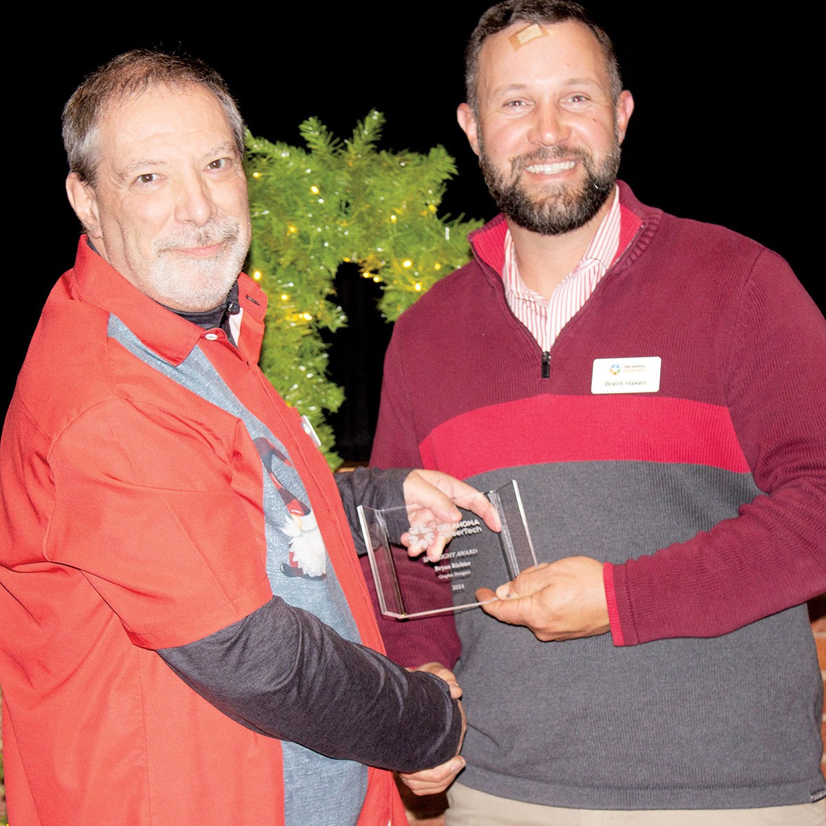 Bryan Richter, left, graphic designer in the Oklahoma CareerTech Communications and Marketing division, received the Spotlight Award. With him is Brent Haken, state director.