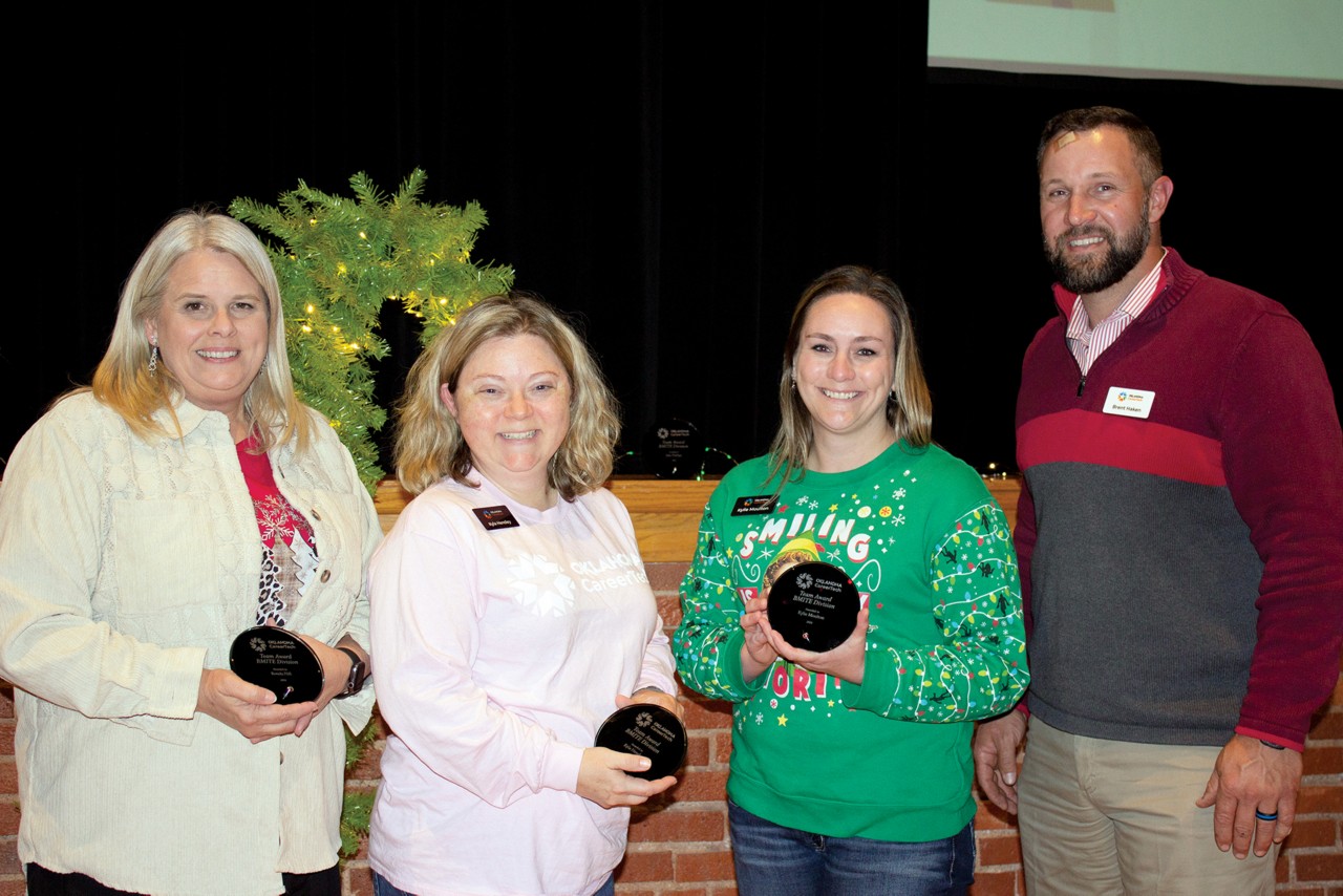 Program specialists in the Business, Marketing and Information Technology Education division won the Team Award. Pictured are, from left, Ronda Hill, information technology and web and digital communications; Kyla Hensley, information technology; Kylie Moulton, business management and administration; and Brent Haken, state director. Not pictured is Jake Phillips, finance and marketing program specialist.