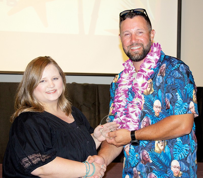 Brenna Long, left, Communications and Marketing administrative assistant, received a Rising Star Award for taking on extra duties when a co-worker left her division and offering to help co-workers who needed assistance. With her is State Director Brent Haken.