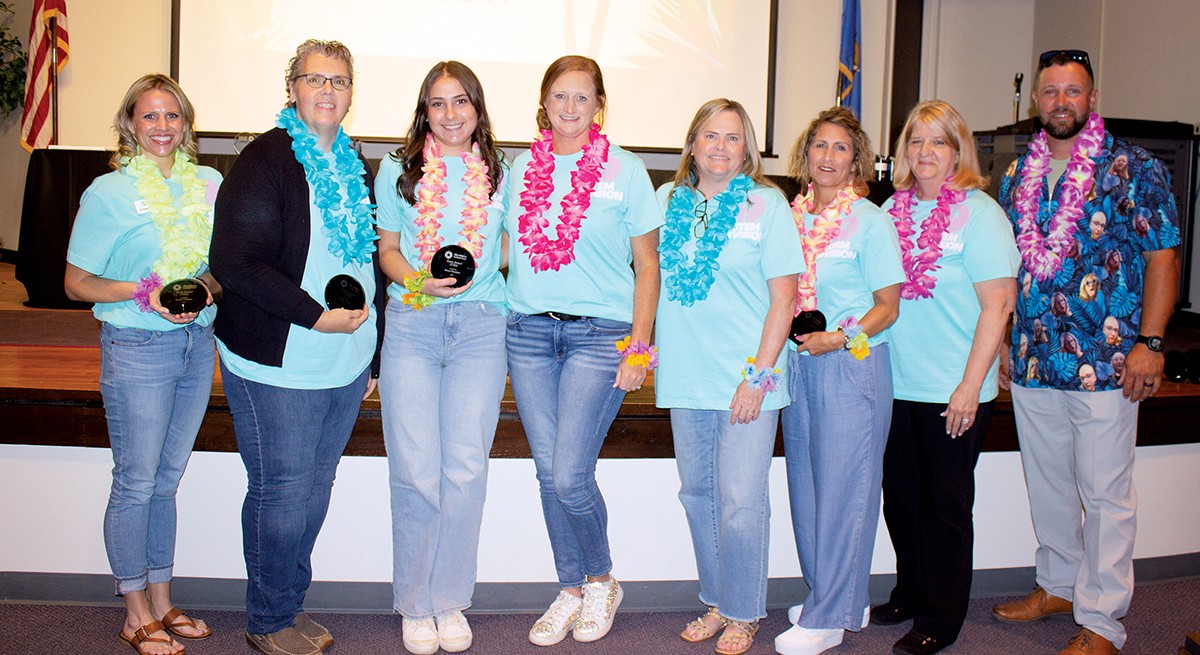 The STEM division received a team Spotlight Award for its work visiting programs, teachers and administrators; helping new programs grow; and building industry partnerships. Pictured are, from left, Kristye O'Mealey, Angela Teeman, Karsyn Bradshaw, Tara Royal, Tami Redus, Kelli Carnes, Tonja Norwood and State Director Brent Haken.