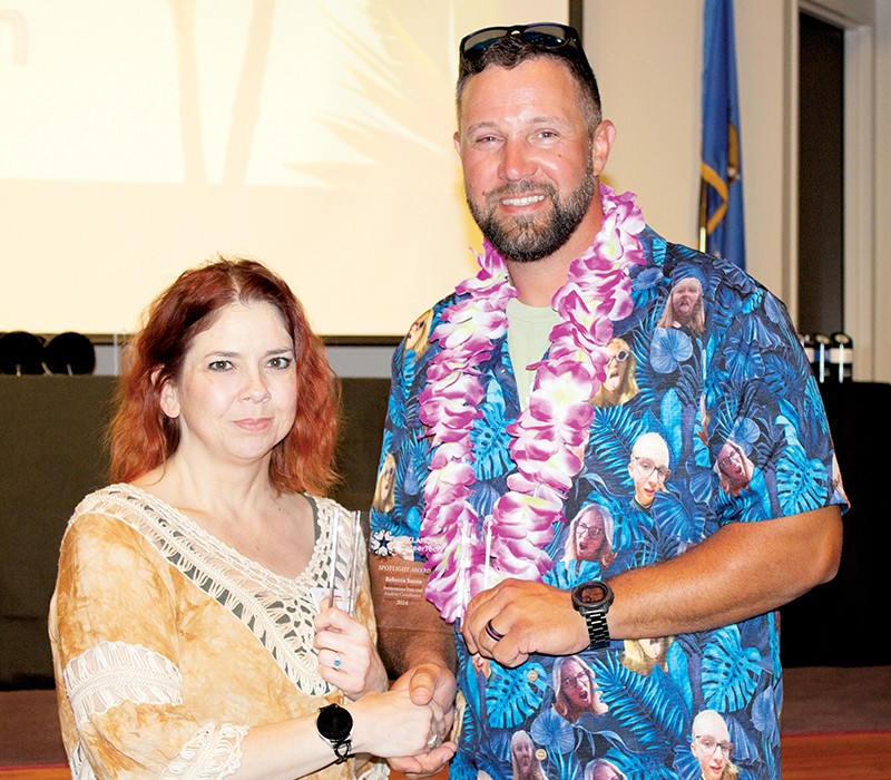 Rebecca Saxon, left, received a Spotlight Award for her work helping Skills Centers staff members learn a new student information system. With her is State Director Brent Haken.
