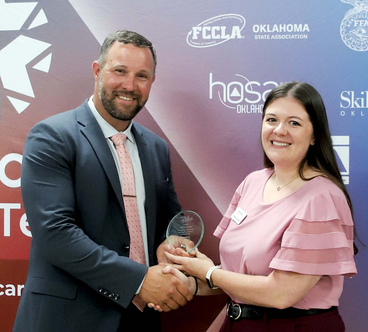 Ashley Jacobs, WED regional coordinator at ODCTE, received a Rising Star Award at the 2025 spring state staff meeting. With her is CareerTech State Director Brent Haken.