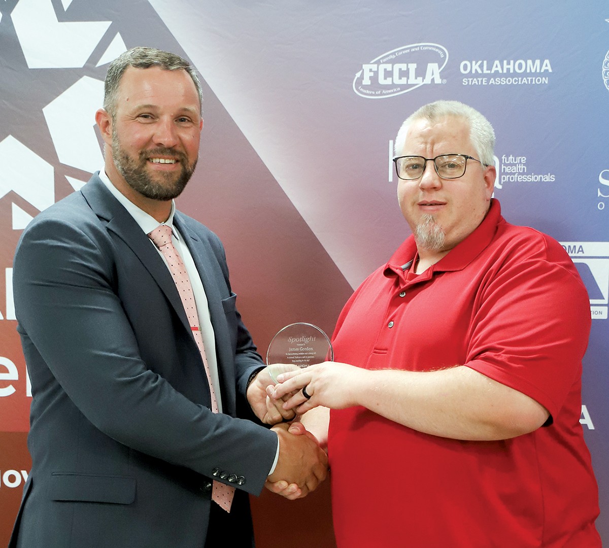 James Gordon, right, health sciences education administrative assistant at ODCTE, received the Spotlight Award at the 2025 spring state staff meeting. With him is CareerTech State Director Brent Haken.