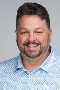 Staff photo of Jake Phillips, State DECA Adviser and Region 3 program coordinator in the business, marketing and information technology education division.