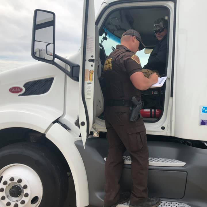 State Trooper writing a citation to a commerical motorist