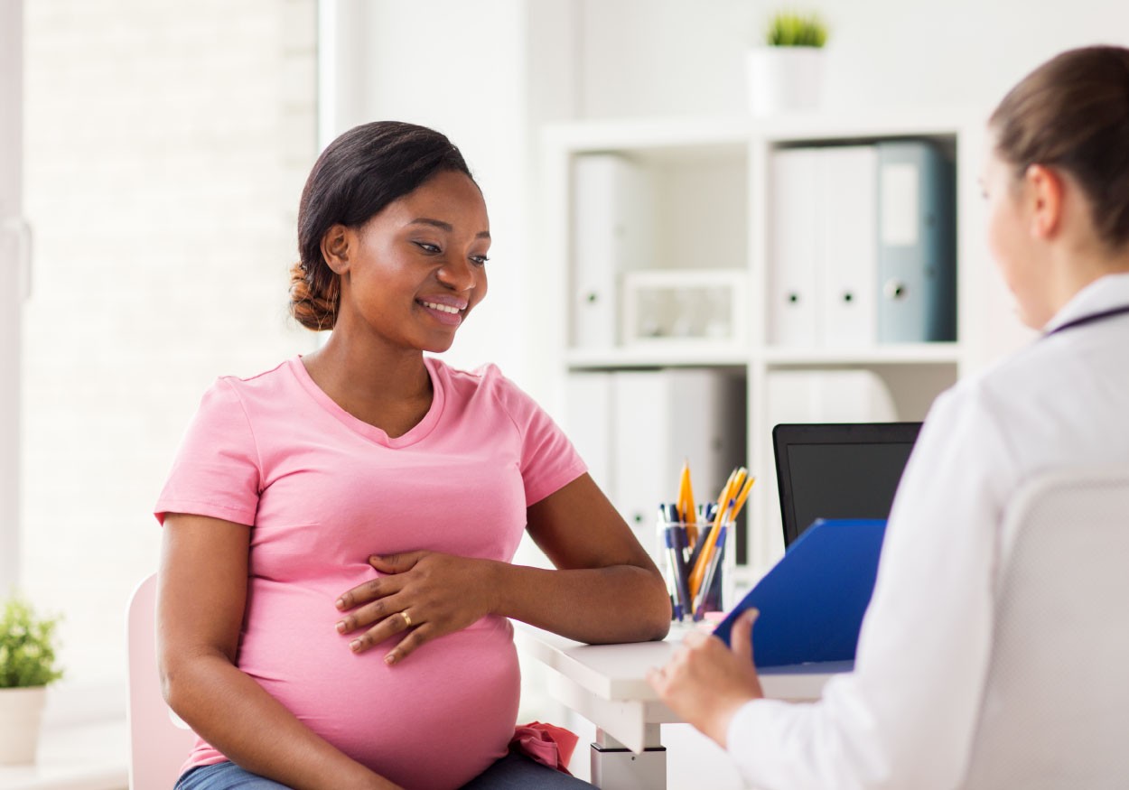 Pregnant African American Woman visits with Doctor