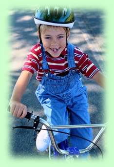 boy child riding a bike with helmet