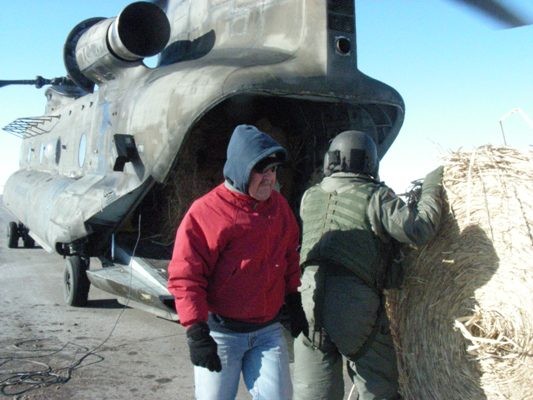final hay bale being loaded onto Chinook.