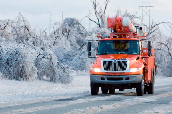 Iced over roads and power lines sagging with an OGE truck on the road. 