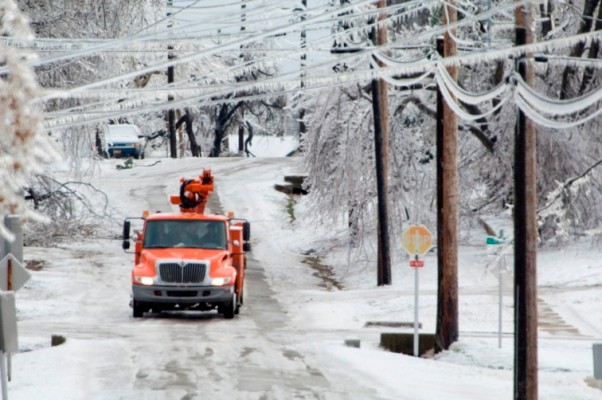 Iced over roads and power lines sagging with an OGE truck on the road. 