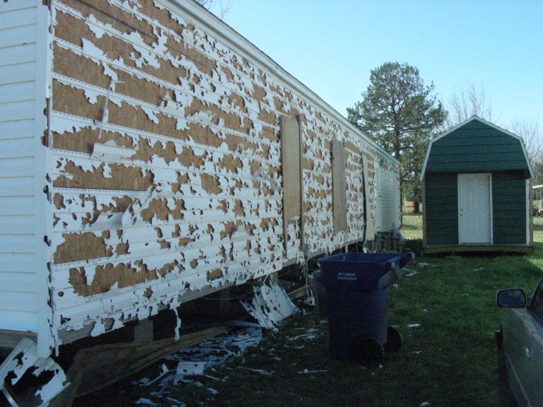 wind damage that pulled the siding off a house. 