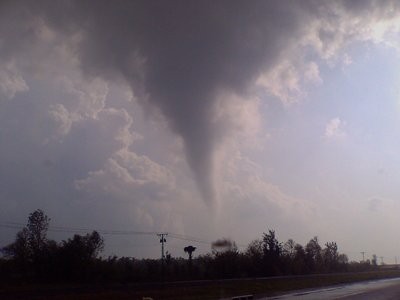 Funnel cloud extending toward ground.