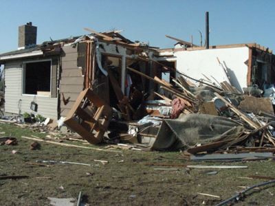 Half a home missing from tornado damage.