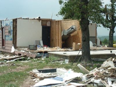 Half a home missing from tornado damage.