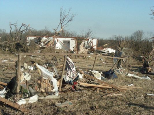 Trailor home damaged and storm debris scattered every where. 