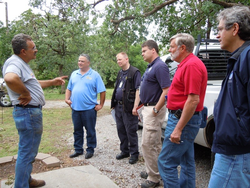 Six men outside talking.