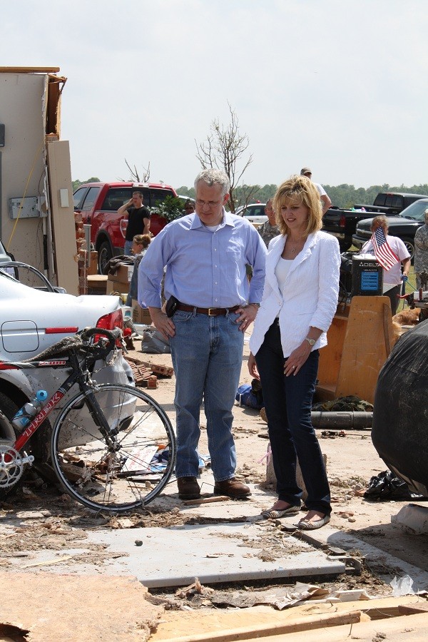 Gov. Henry and his wife look at storm shelter in the ground. 