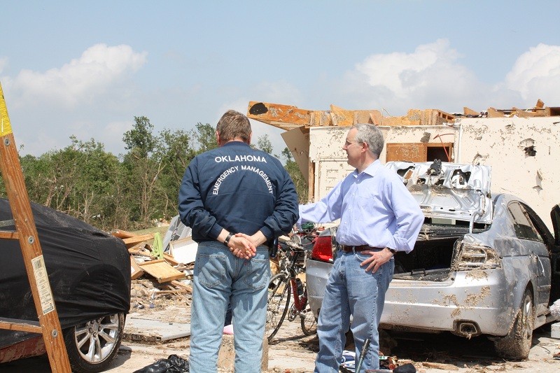 Gov. Henry looks over storm damaged builidng. 