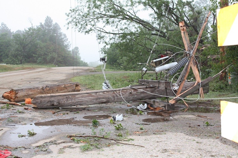 a power line poll broke in half with lines all around.