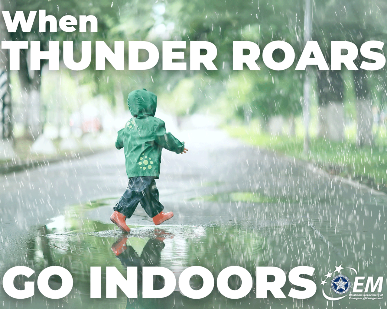 When Thunder Roars, Go Indoors; photo of a child in a raincoat walking in the rain. Logo, Oklahoma Department of Emergency Management. 