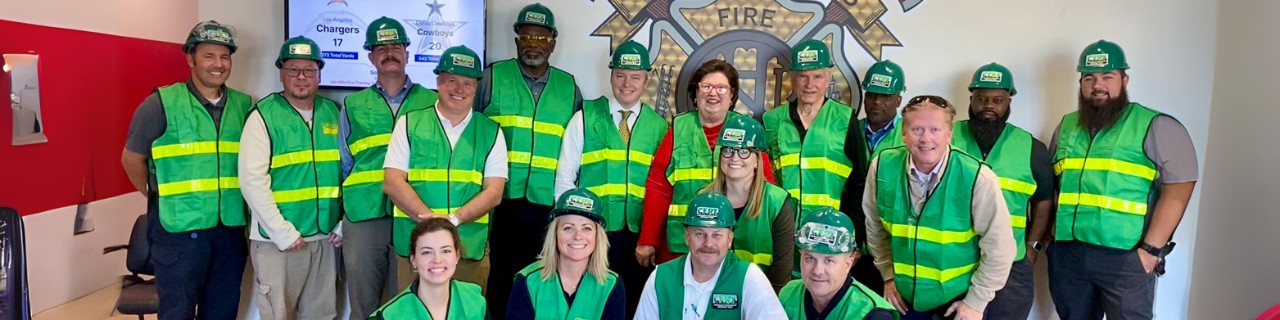 A group of volunteers with safety vests on