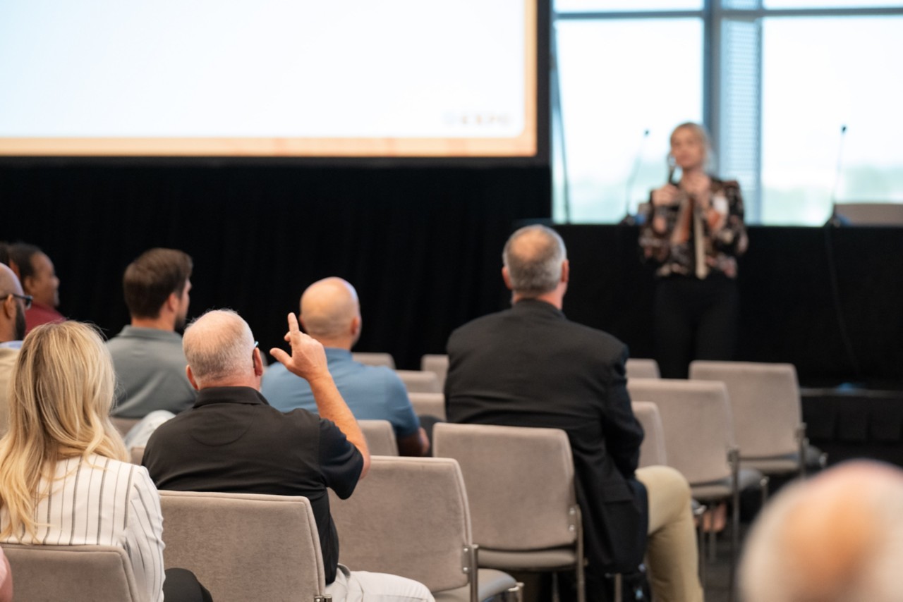 2024 attendee raises his hand at the Statewide Contracts breakout session.