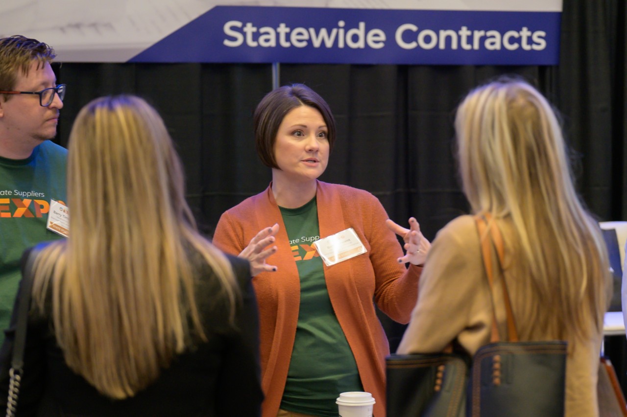 Statewide Contracts employees talking with attendees
