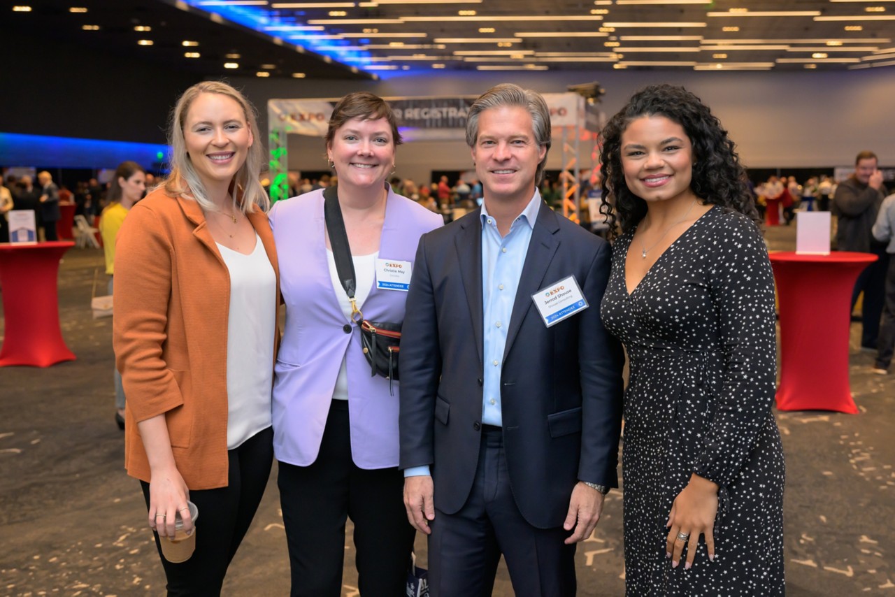 Four employees gathered for a photo