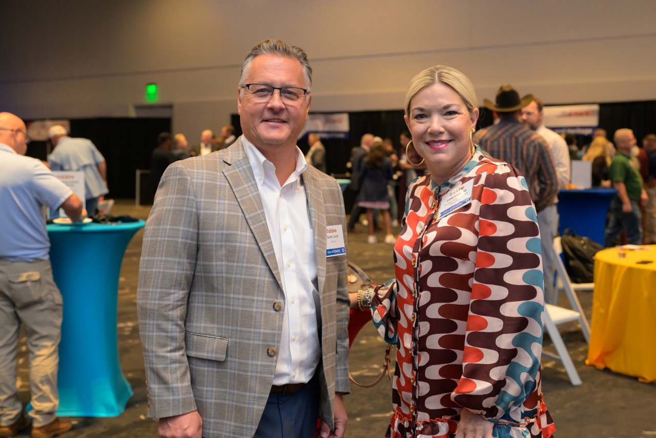 Two attendees smiling