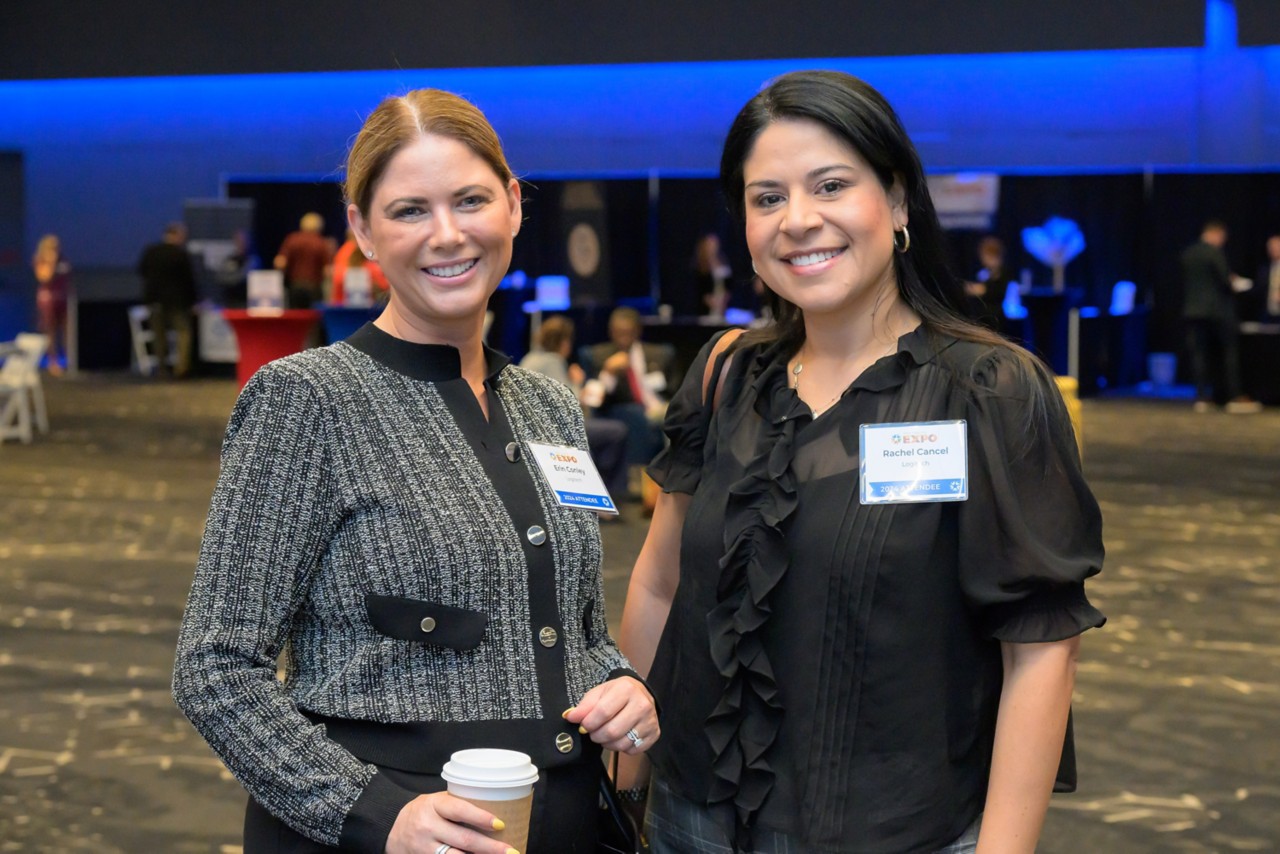 Two attendees smiling together