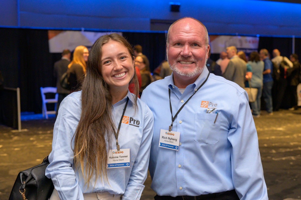 Two Home Depot attendees smiling together