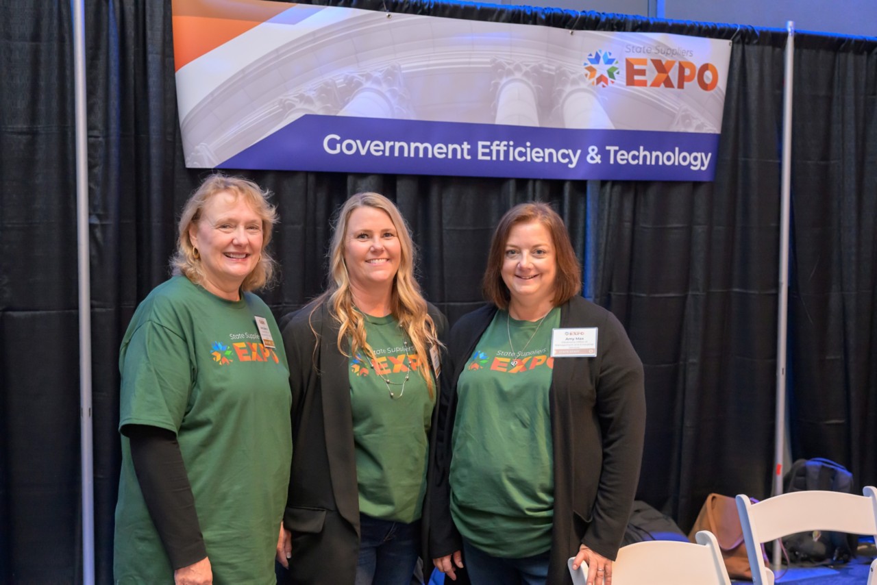 Three state employees at the Government Efficiency and Technology booth