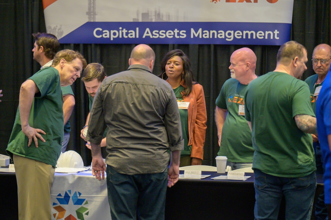 Atendees at the 2024 State Suppliers Expo visit the Capital Assets Management booth.