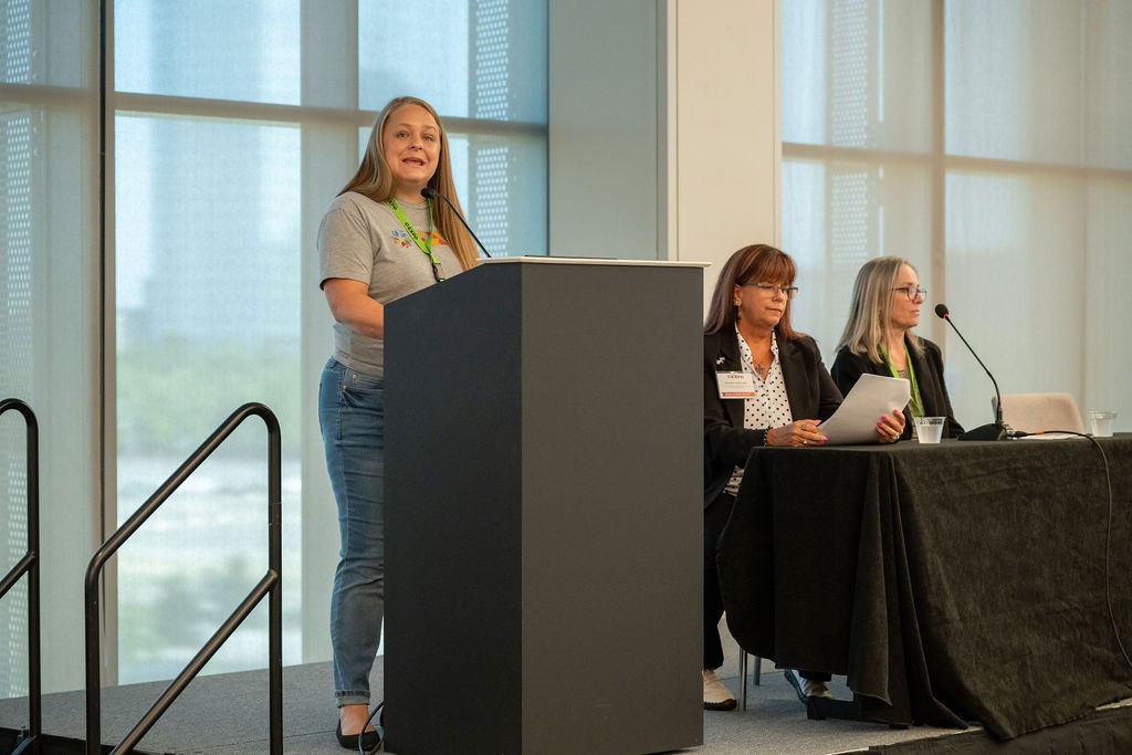 Procurement Outreach Specialist Emily Duren speaking at podium next to Statewide Contract Opportunities speakers