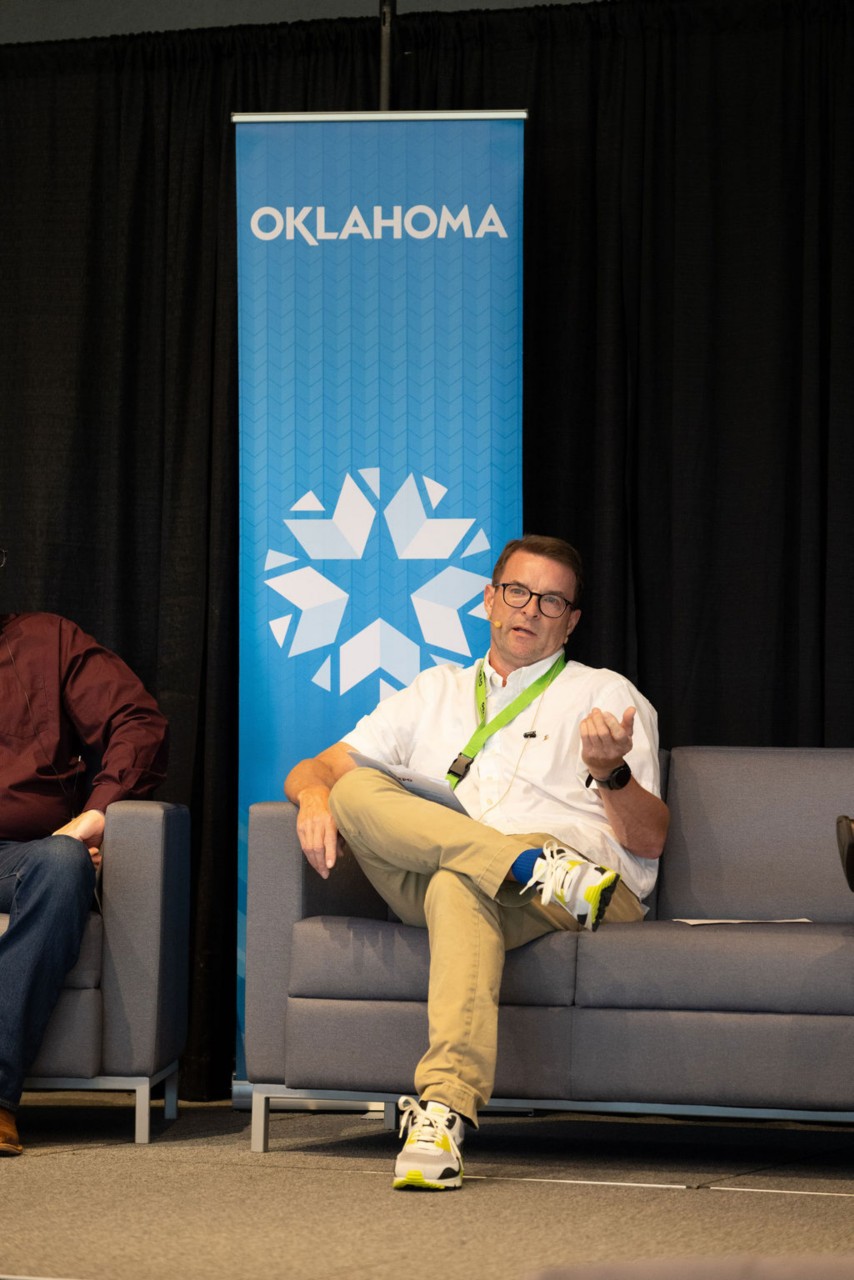 OMES Cyber Operations Manager Bobby Goddard seated on couch and speaking at Cybersecurity in State Government breakout session