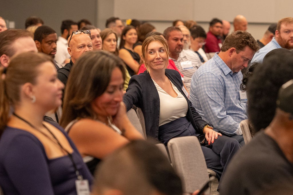 Breakout session attendee smiling in the audience