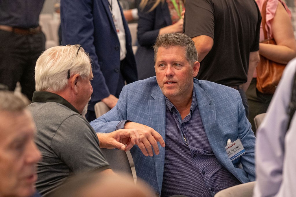 Two suppliers sitting and talking after breakout session