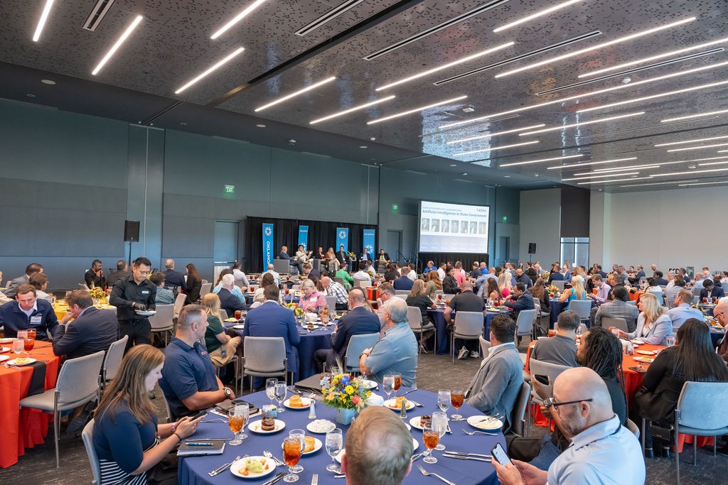 Luncheon audience with panelist stage in the background