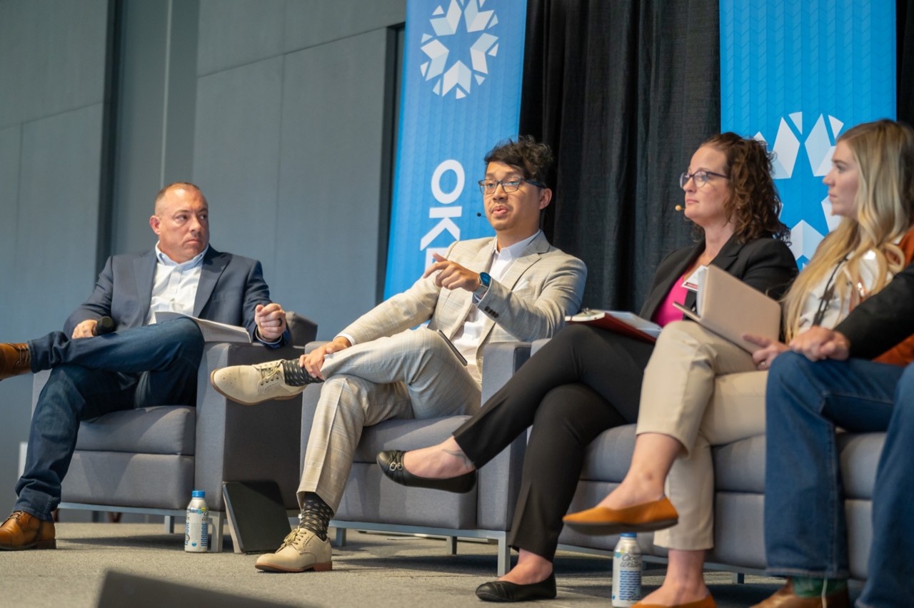 OMES Chief Technology Officer Tai Phan addresses audience from luncheon panel stage