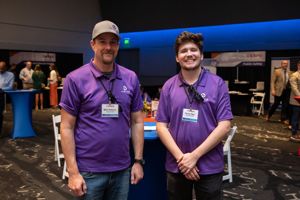 Supplier attendees Cyrus Ray and Matt Holman smile in ballroom