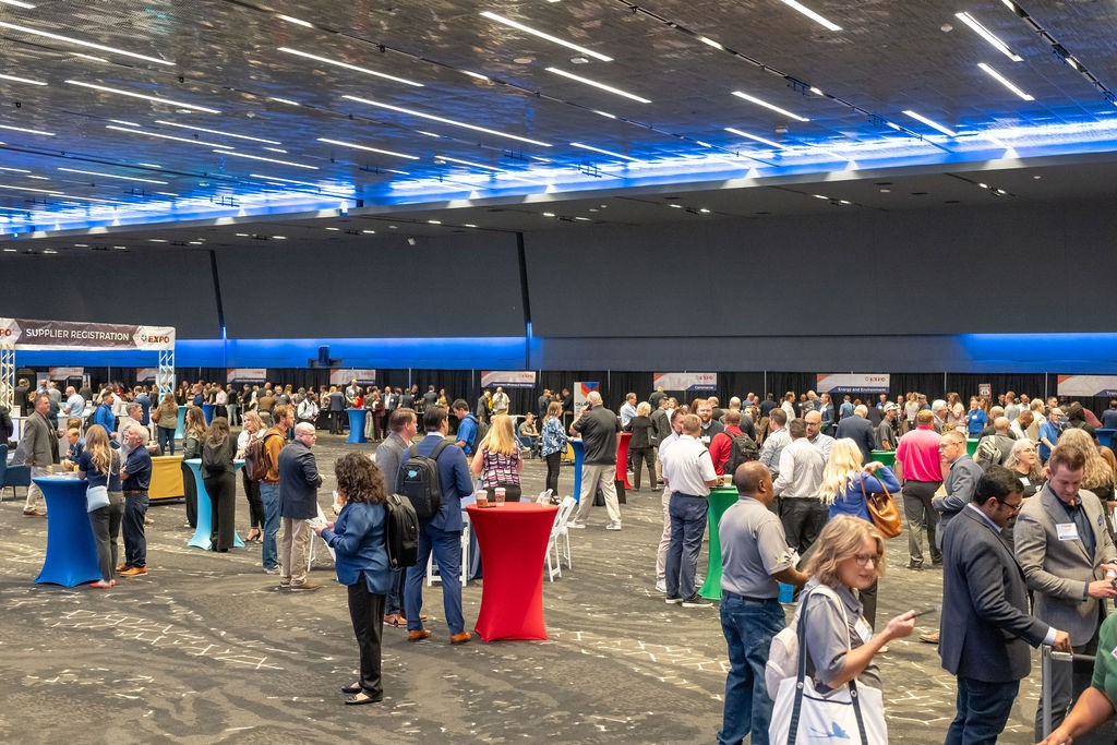 Wide angle of supplier attendees networking in the ballroom