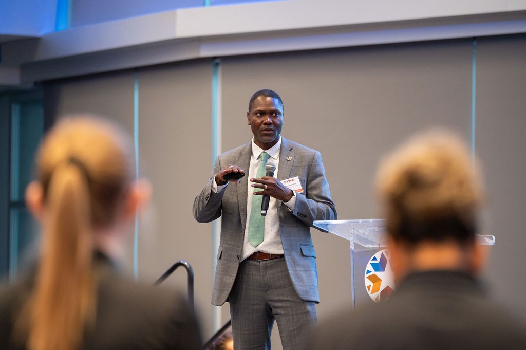 Two attendees listening to midday speaker Adlwyn Sappleton