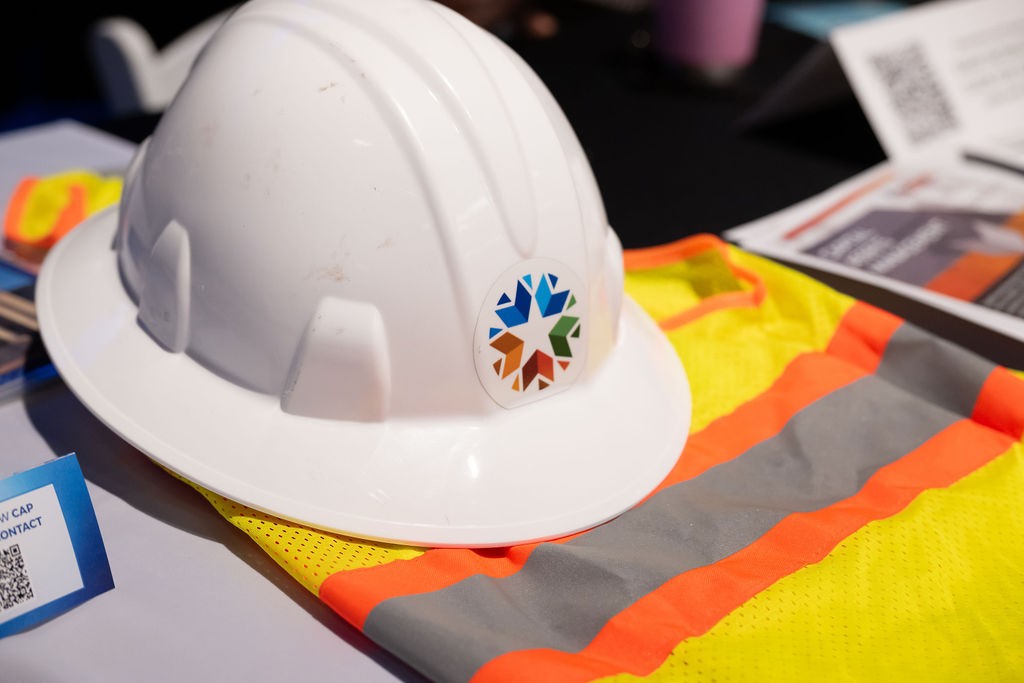 Hard hat and safety vest at Capital Assets Management booth